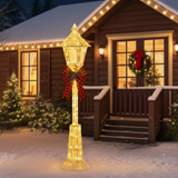 Decorative outdoor lamp post with lights in front of a house with Christmas decorations