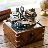 Vintage sextant on a wooden box with a blurred globe in the background
