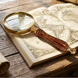 Vintage magnifying glass on an open book with world map