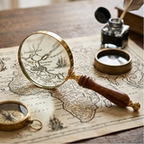 Vintage magnifying glass and compass on an old map