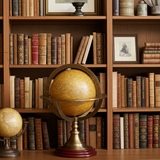 Vintage globe on a wooden shelf with books and decorative items