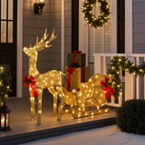 Decorative outdoor Christmas scene with illuminated reindeer, sleigh, and presents on a porch.