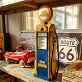 Vintage-style Golden Fleece gas pump on a wooden shelf with a red toy car and Route 66 sign in the background.