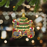 Decorative Christmas ornament with a tree and bears on a blurred Christmas tree background.