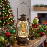 Decorative lantern with a Grinch figure inside, surrounded by Christmas decorations.
