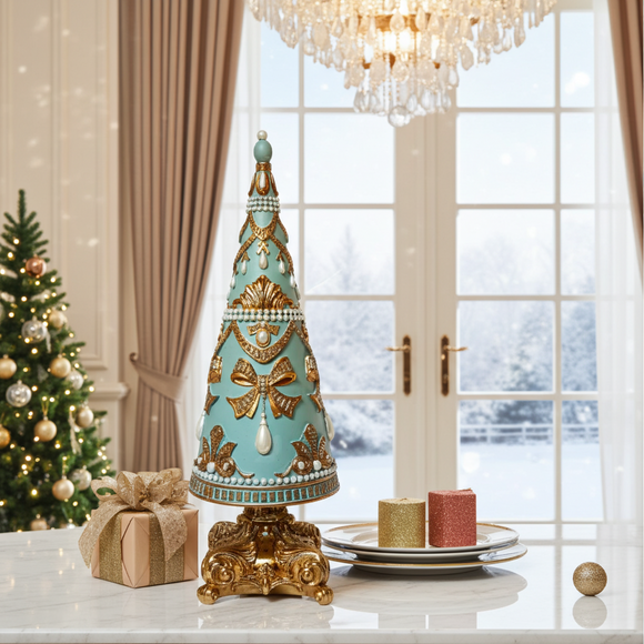 Decorative Christmas tree with gold and blue accents on a table in a room with a window view of snow.