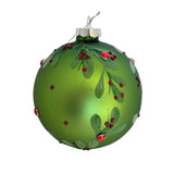 Green Christmas ornament with red berries and green leaves on a white background
