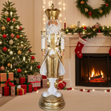 Decorative nutcracker figure in a festive room with Christmas tree and fireplace.