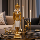 Decorative nutcracker figure with gold armor on a table with candles and small deer figurines.