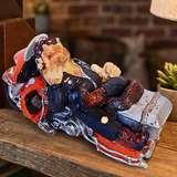 Decorative sculpture of a motorcycle with a shell on a wooden surface