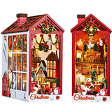 Two Christmas-themed miniature houses with lights and decorations on a white background.
