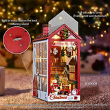 Decorative Christmas house with lights and music box on a blurred festive background