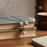 Necklace with pearl pendant on a book