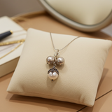 Pearl necklace on a beige cushion with a blurred background