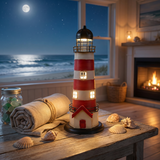 Decorative lighthouse on a table with ocean view and fireplace in the background