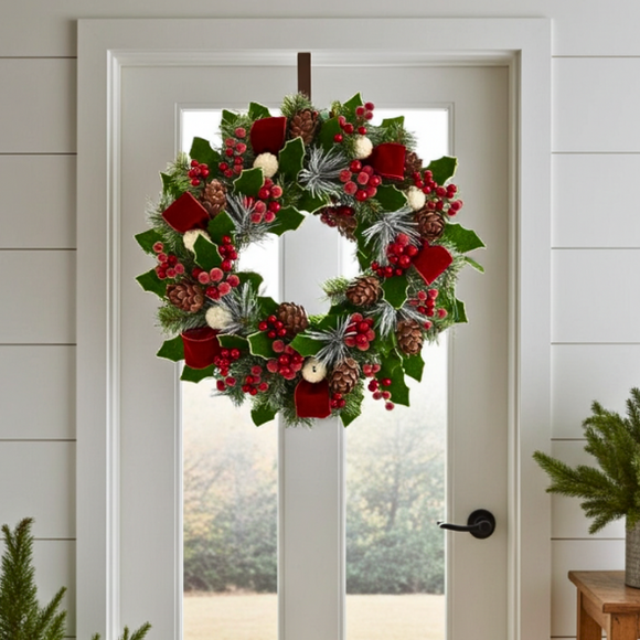 Decorative Christmas wreath on a door with festive elements.
