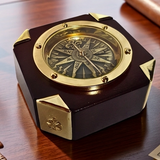 Decorative  and working Star compass with gold and wood finish on a wooden surface
