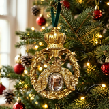 Gold crown ornament on a decorated Christmas tree with red and gold decorations.