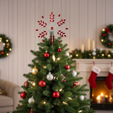 Decorated Christmas tree with ornaments and a star topper in a festive living room.