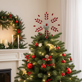 Decorated Christmas tree with red ornaments and a star topper in a room with a fireplace and wreath.
