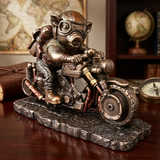 A decorative steampunk-style figurine of a pig riding a motorcycle on a stone base, displayed on a wooden surface with a map, globe, and compass in the background.