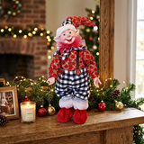 Elf figurine on a mantelpiece with Christmas decorations