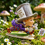 Colorful figurine of a character with a top hat in a garden setting