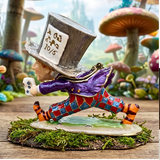 Colorful figurine of a character with a top hat in a whimsical forest setting