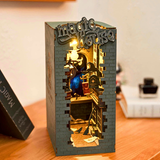Decorative box with a miniature scene inside, resembling a magical castle, on a wooden surface.