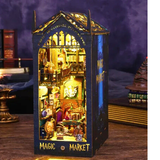Decorative model of a 'Magic Market' with illuminated interior on a wooden surface.