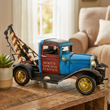 Model of a vintage tow truck on a wooden surface with a blurred background