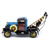 Model of a vintage tow truck with 'Mike's Towing Service' branding on a white background