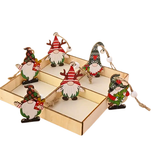 Set of Christmas-themed gnome figurines in a decorative box on a white background