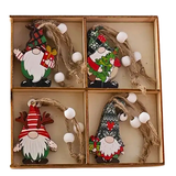 Set of four Christmas-themed gnome ornaments in a decorative box.