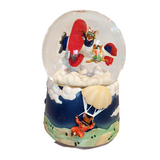A musical glitter globe featuring two mice in a red baron airplane with white fluffy clouds, displayed against a blue background.